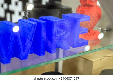 Objects letters printed on 3D printer close-up. Models letter 3D printed from molten plastic blue color. FDM technologies. Additive progressive modern new technology. 3D printing innovation technology
