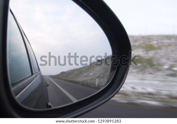 Objects in the mirror. Car back mirror \
and road. Side rear mirror of car show straight road - view of a\
road side of the car, Drive Thru, Traveling\
Theme