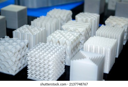 Objects printed on 3d printer made of white plastic close-up. Models created on 3D printer from filament. Modern new prototyping technology. Additive automation manufacturing Fused deposition modeling