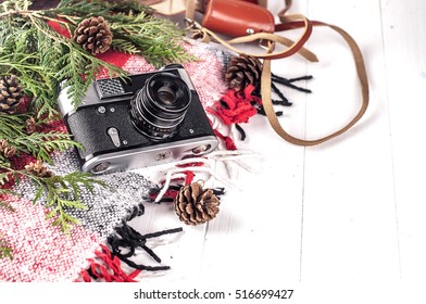 Objects top view lifestyle essentials of artist. Retro vintage film camera and a blanket. Christmas style