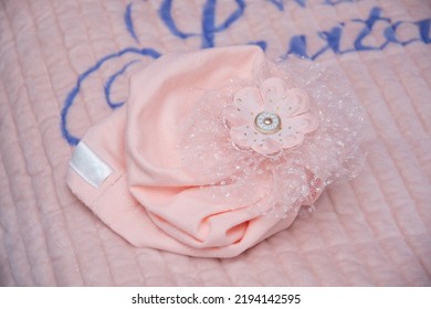 Objects Used At A Girl's Baptism, Pink Flower, Pink Baby Hat,