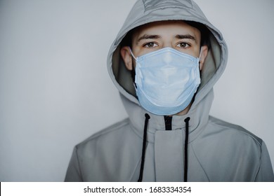 obligatory medical mask on everyone who leaves home during quarantine. Photo of a young man wearing a jacket and medical mask