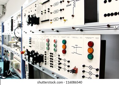 Oblique angle view of a long row of control panels in an electronics lab