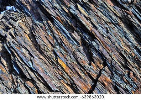 The oblique texture of colorful layered stone of Shale from Caucasus