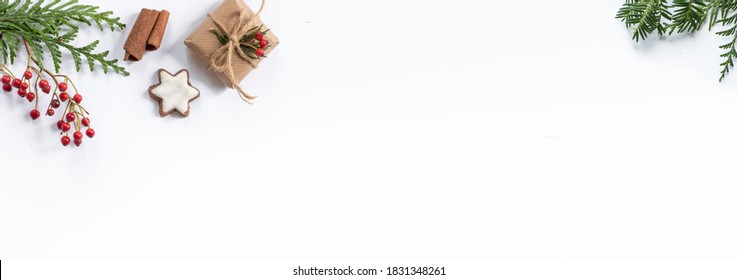 Oblong Christmas Banner With Small, Wrapped Gifts And Other Xmas Decorations Like Spruce And Fir Twigs Isolated On White Background And Lots Of Space For Text.