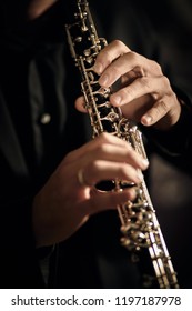 Oboe Player On Black Background