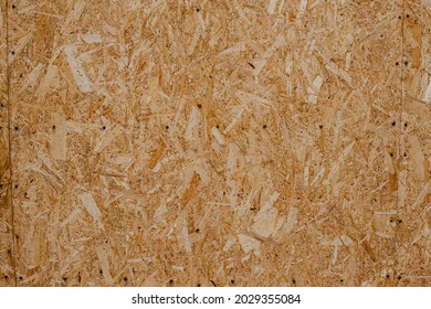 OBS Background. Textured Background Of Oriented Strand Board Of Light Brown Color Consisted Of Pressed Sawdust 