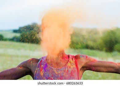 obscured view of african american man throwing powder during holi festival