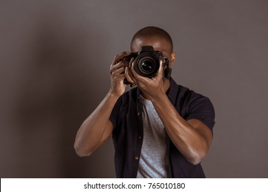 Obscured View Of African American Photographer Taking Picture On Photo Camera