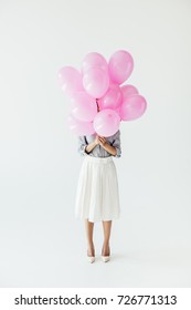 Obscured View Of Woman Holding Bunch Of Balloons In Hands Isolated On Grey