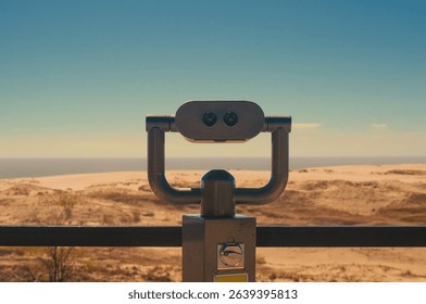 Observation deck with fixed observation binoculars. View on a sand dune and seashore