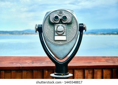 Observation deck with Paid binocular telescope, view on shore