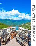 Observation deck with stone wall and wooden benches of Mountain hotel at beautiful setting of Rhodopes Mountain, Bulgaria. Picture taken on September 5th 2014