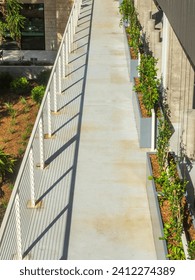 Observation deck and walkway on the exterior of a new downtown parking garage, part of a major expansion at a botanical garden complex in Sarasota, Florida. Bird's-eye view on a January afternoon.