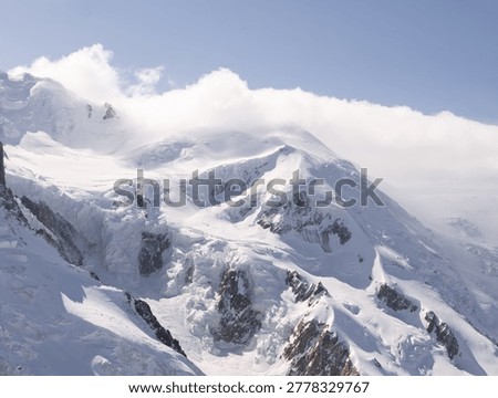 Observation structures and viewing areas frame the snowy alpine scenery at Aiguille du Midi above Chamonix.