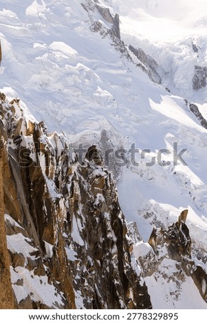 Observation structures and viewing areas frame the snowy alpine scenery at Aiguille du Midi above Chamonix.