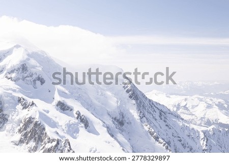 Observation structures and viewing areas frame the snowy alpine scenery at Aiguille du Midi above Chamonix.