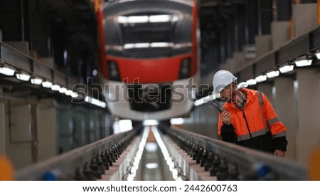 Observing the engineer working on the Electrical train tracks.
