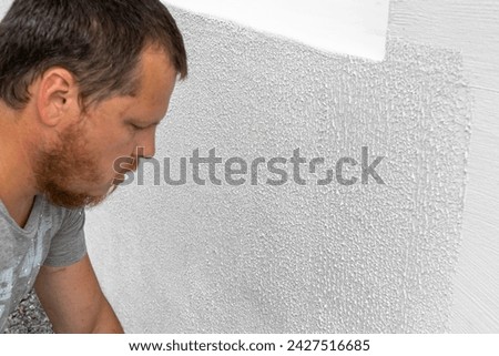 Observing a Man's Preliminary Steps Before Applying Putty for Wall Renovation.