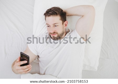 obsession with cell phone costs sleep and recreation time when lie in bed and forget about time  Stock photo © 