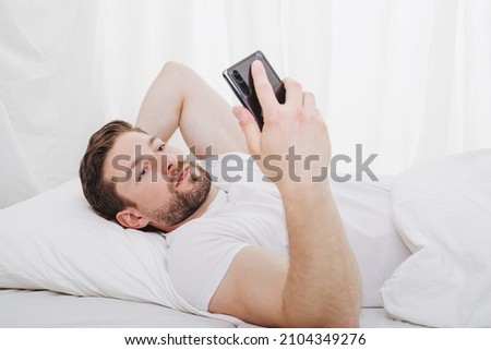 obsession with cell phone costs sleep and recreation time when lie in bed and forget about time Stock photo © 