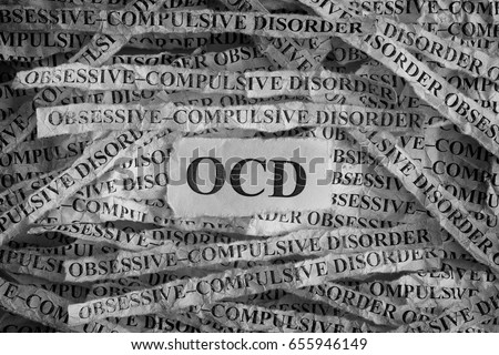 Obsessive compulsive disorder (OCD). Torn pieces of paper with the words Obsessive compulsive disorder. Concept Image. Black and White. Closeup.