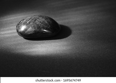 Obsidian mexican stone black vulvanic - Shutterstock ID 1695674749