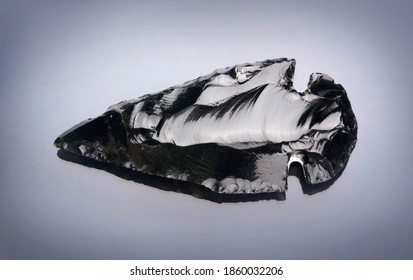 Obsidian Stone Arrowhead On Black Background