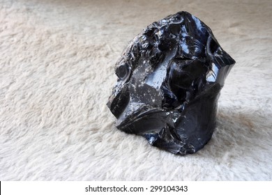 Obsidian stone from a free beach of the Lipari island , one of the Aeolian Islands in Sicily, Italy.   - Shutterstock ID 299104343