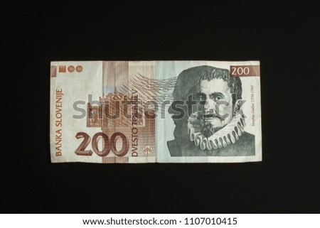 Obsolete 200 tolar bill of Slovenia, became obsolete with introduction of Euro currency, isolated on black background Stock photo © 