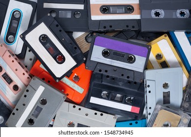 Obsolete technology of audio recording and playback format audio cassette tapes ,top view.Pile of vinyl cassette tapes .