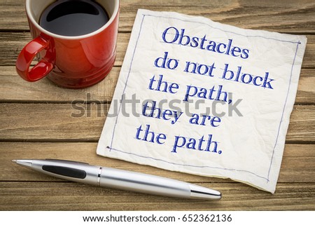 Obstacles do not block the path, there are the path - handwriting on a napkin with a cup of coffee
