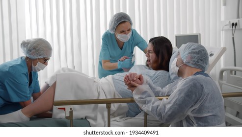 Obstetricians Husband Supporting Female Giving Birth Stock Photo ...