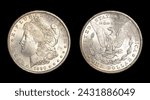Obverse (heads) and reverse (tails) of U.S. 1890-S Morgan silver dollar isolated on black background. Brilliant uncirculated with slight gold toning and bag marks. Minted in San Francisco.
