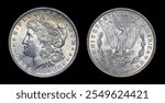 Obverse (heads) and reverse (tails) of U.S. 1884-O Morgan silver dollar isolated on black background. Brilliant uncirculated with bag marks and slight gold toning. Minted in New Orleans.