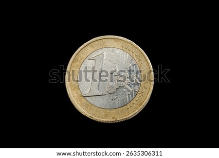 Obverse or heads side of a 1 euro coin, Overhead view showing the face value and European map design, directly above view isolated on a black background.