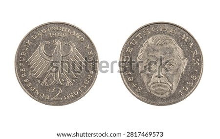 Obverse and reverse of a West German Deutsche Mark commemorative coin are shown. The coin features a design with the German eagle and a portrait. Focus is on the coin details.