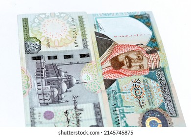Obverse sides of Saudi Arabia 20 twenty riyals banknote with 20 LE twenty Egyptian pounds bill isolated on a white background, Selective focus of Egyptian and Saudi money exchange rate