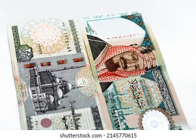 Obverse sides of Saudi Arabia 20 twenty riyals banknote with 20 LE twenty Egyptian pounds bill isolated on a white background, Selective focus of Egyptian and Saudi money exchange rate