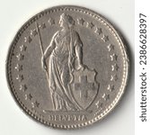 Obverse of Switzerland, 1 franc, 1969 which depicts Helvetia, the Swiss female allegorical character, dressed in a long toga. Image isolated on white background.