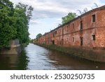 Obvodny Canal in Kronstadt, view of old drainage canal with an abandoned warehouse building on the bank