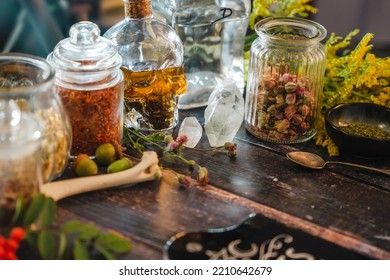 Occult Altar With Cristals, Herbs And Old Bones. Medicinal Plants In Vintage Bottles. Magical Potion In A Skull Bottle. Esoteric, Pagan, Wicca And Witchcraft With Magical Objects. Halloween Concept.