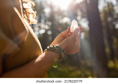 Occult Science And Supernatural Concept - Close Up Of Woman Or Witch With Semiprecious Crystal Or Gemstone Performing Magic Ritual In Forest