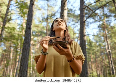 Occult Science And Supernatural Concept - Young Woman Or Witch With Smoking Palo Santo Stick Performing Magic Ritual In Forest