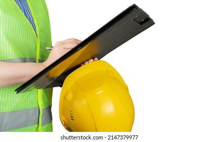 Occupational Safety And Health, Inspector In A Protective Vest With A Construction Helmet Writes With A Pen On A Clipboard, Isolated On White Background