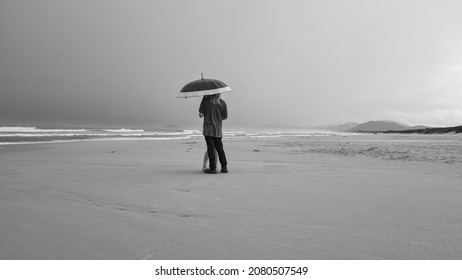 Ocean Beach Couple Umbrella Rain Beach Grey Clouds 