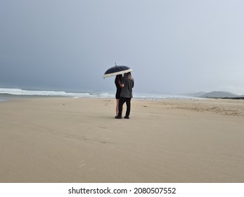 Ocean Beach Couple Umbrella Rain Beach Grey Clouds 