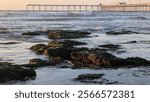 Ocean Beach Pier in San Diego California during king tides at low tide where the tidal pools are visible.