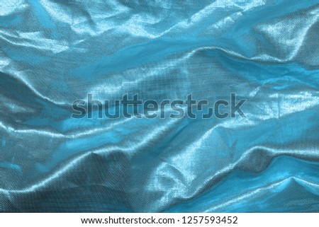 Ocean blue textile background. Silk cloth texture. Fabric pattern.