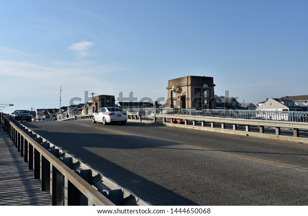 OCEAN CITY, NEW\
JERSEY/USA - JUNE 27, 2019: Cars crossing an old draw bridge near\
Ocean City New Jersey
